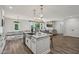 Spacious, open kitchen with granite island flowing into the living area and a view of the backyard through large windows at 14729 Erica Ln, Carmel, IN 46033