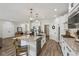 Modern kitchen featuring a large island with a stainless steel sink, granite countertops, and sleek stainless steel appliances at 14729 Erica Ln, Carmel, IN 46033