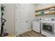 Well-equipped laundry room with modern washer and dryer, shelving, and a practical layout for efficient laundry tasks at 14729 Erica Ln, Carmel, IN 46033