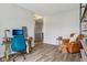 Bright living room featuring wood floors, a blue desk chair, and a tan leather accent chair at 14729 Erica Ln, Carmel, IN 46033
