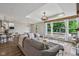 Bright, open living space with modern furniture, large windows, and views of the outdoor deck at 14729 Erica Ln, Carmel, IN 46033