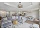 Open floor plan features a living room with gray couches and a kitchen with a dining table at 14729 Erica Ln, Carmel, IN 46033