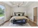 Bright main bedroom features a chandelier, wood floors, and a bench in front of the bed at 14729 Erica Ln, Carmel, IN 46033