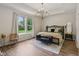 Bright main bedroom features a chandelier, wood floors, and a bench in front of the bed at 14729 Erica Ln, Carmel, IN 46033