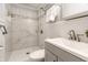 Bathroom with a walk-in shower featuring white tile and a gray vanity with updated sink and hardware at 1515 Randall Rd, Indianapolis, IN 46240