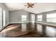 Bedroom featuring hardwood floors, multiple windows, and a double-door closet providing ample space at 1515 Randall Rd, Indianapolis, IN 46240
