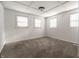 Bedroom with neutral carpet, a ceiling light, and multiple windows allowing plenty of natural light at 1515 Randall Rd, Indianapolis, IN 46240