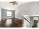 Grey bedroom with hardwood floors, a staircase, and a window allowing natural light at 1515 Randall Rd, Indianapolis, IN 46240