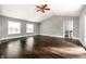 Bedroom featuring hardwood floors, multiple windows, and easy access to other areas at 1515 Randall Rd, Indianapolis, IN 46240