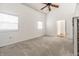 Spacious bedroom featuring neutral carpet, a ceiling fan, and ample natural light from multiple windows at 1515 Randall Rd, Indianapolis, IN 46240