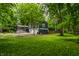View of two-story home with a screened-in porch and a green lawn at 1515 Randall Rd, Indianapolis, IN 46240