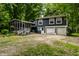 Two-story home with screened-in porch and attached two-car garage surrounded by trees at 1515 Randall Rd, Indianapolis, IN 46240