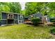 The exterior features a multilevel deck, a pond, and a lush, green lawn at 1515 Randall Rd, Indianapolis, IN 46240
