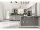 Eat-in kitchen with gray cabinets, tile backsplash, and a convenient breakfast bar for casual dining at 1515 Randall Rd, Indianapolis, IN 46240