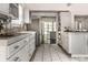 Modern kitchen with sleek white cabinets, stainless steel appliances, and stylish tile flooring, offering ample counter space at 1515 Randall Rd, Indianapolis, IN 46240