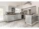 Updated kitchen with gray cabinets, stainless steel appliances, and breakfast bar with access to the backyard at 1515 Randall Rd, Indianapolis, IN 46240
