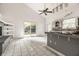 Bright kitchen with white tile flooring, gray cabinets, and stainless steel appliances opens to an outdoor patio at 1515 Randall Rd, Indianapolis, IN 46240