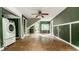 An open living room featuring a ceiling fan, tile floors and natural light from the glass patio doors at 1515 Randall Rd, Indianapolis, IN 46240