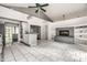 Bright open living area with a brick fireplace, modern lighting, and gray accent walls to the kitchen at 1515 Randall Rd, Indianapolis, IN 46240