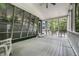 Spacious screened-in porch with white flooring and views of the surrounding trees at 1515 Randall Rd, Indianapolis, IN 46240