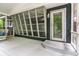 Covered and screened-in porch with white furniture and view to the backyard at 1515 Randall Rd, Indianapolis, IN 46240