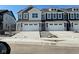 New two-story townhome with a modern garage and stylish color palette on a sunny day at 15262 Swallow Falls Way, Fishers, IN 46037