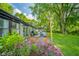Lush backyard featuring patio space, outdoor seating, landscaping, and beautiful plants at 1605 Westlane Rd, Indianapolis, IN 46260