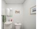 Simple bathroom with pedestal sink, framed mirror, and light colored walls at 1605 Westlane Rd, Indianapolis, IN 46260