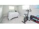 Bright bedroom with neutral tones, exercise equipment, and ample natural light at 1605 Westlane Rd, Indianapolis, IN 46260