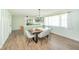 Dining room with a custom live edge table, modern lighting, and natural light at 1605 Westlane Rd, Indianapolis, IN 46260