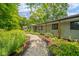 Charming home exterior enhanced by a lush garden and a quaint walkway at 1605 Westlane Rd, Indianapolis, IN 46260
