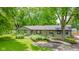 Charming single-story home featuring a well-manicured lawn and a beautiful garden at 1605 Westlane Rd, Indianapolis, IN 46260