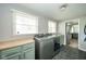 Bright laundry room with tile flooring, modern washer and dryer, and plenty of storage space at 1605 Westlane Rd, Indianapolis, IN 46260
