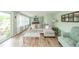 Light-filled living room with wood flooring features comfortable seating and backyard access at 1605 Westlane Rd, Indianapolis, IN 46260