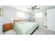 Cozy main bedroom features a ceiling fan, neutral walls and carpet, and ample natural light at 1605 Westlane Rd, Indianapolis, IN 46260