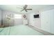 Bright main bedroom features a ceiling fan, neutral walls and carpet, and ample storage space at 1605 Westlane Rd, Indianapolis, IN 46260