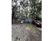 Fenced-in backyard features a gravel driveway, landscaping, and a detached garage at 1728 N Somerset Ave, Indianapolis, IN 46222