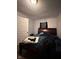 Comfortable bedroom with dark furniture, soft lighting and a window for natural light at 1728 N Somerset Ave, Indianapolis, IN 46222