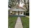 Charming bungalow featuring a covered porch, green trim, and inviting curb appeal at 1728 N Somerset Ave, Indianapolis, IN 46222
