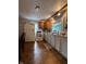 Bright kitchen with plenty of storage, laminate flooring, and a window over the sink at 1728 N Somerset Ave, Indianapolis, IN 46222