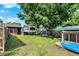 The grassy backyard features mature trees, a camper, and plenty of space for outdoor activities at 1759 Michele Ln, Greenwood, IN 46142