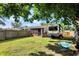 View of home's backyard with sunroom extension, yard, and recreational vehicle parking at 1759 Michele Ln, Greenwood, IN 46142