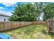Large, grassy backyard is enclosed by a wooden fence, creating a private and secure outdoor space at 1759 Michele Ln, Greenwood, IN 46142