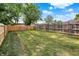 This grassy backyard is fully fenced in wood for added privacy at 1759 Michele Ln, Greenwood, IN 46142