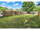 The large grassy backyard is enclosed by a wooden fence, providing privacy and security at 1759 Michele Ln, Greenwood, IN 46142