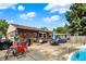 Expansive backyard featuring a pool, brick home exterior, and an outdoor seating area at 1759 Michele Ln, Greenwood, IN 46142
