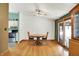 Bright dining area with hardwood floors, ceiling fan, and sliding glass doors leading to the backyard at 1759 Michele Ln, Greenwood, IN 46142