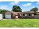 Charming single-story home with a brick and vinyl exterior, well-maintained lawn, and attached two-car garage at 1759 Michele Ln, Greenwood, IN 46142