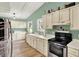Bright eat-in kitchen featuring white cabinets, updated appliances, and wood-look flooring at 1759 Michele Ln, Greenwood, IN 46142