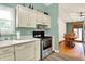 Well-equipped kitchen with stainless steel appliances, bright cabinets, and an adjacent dining area at 1759 Michele Ln, Greenwood, IN 46142
